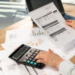 Cropped photo of secretary hands accounting advisor employee employer employment entrepreneur lady in her formalwear shirt she sit behind desk in light loft interior check cost tax